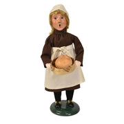 Byers’ Choice Pilgrim Girl figurine holding a basket of freshly baked bread