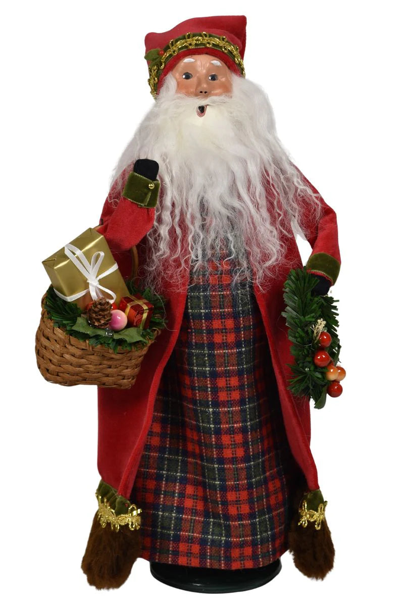 Traditional Santa Claus figure with a plaid skirt, red coat, and white beard holding a gift and basket.