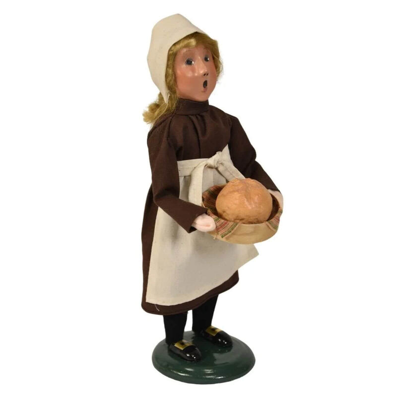Byers’ Choice Pilgrim Girl figurine holding a basket of freshly baked bread